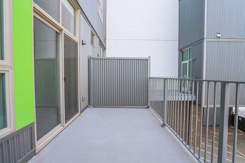 A corridor with a metal railing on the right side.